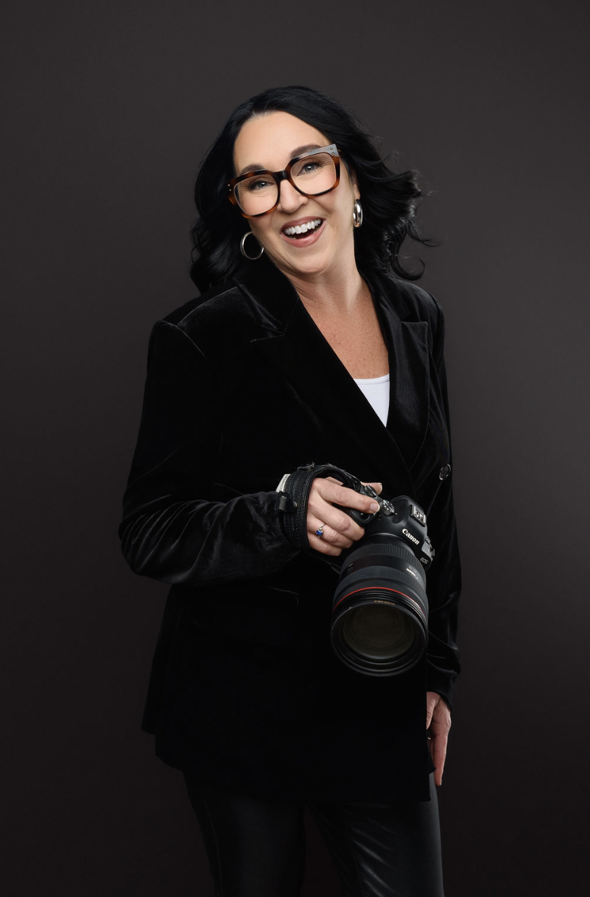 Photographer holding camera smiling and laughing